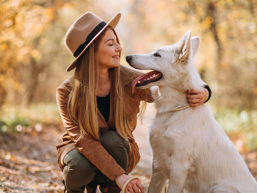 woman petting dog outside